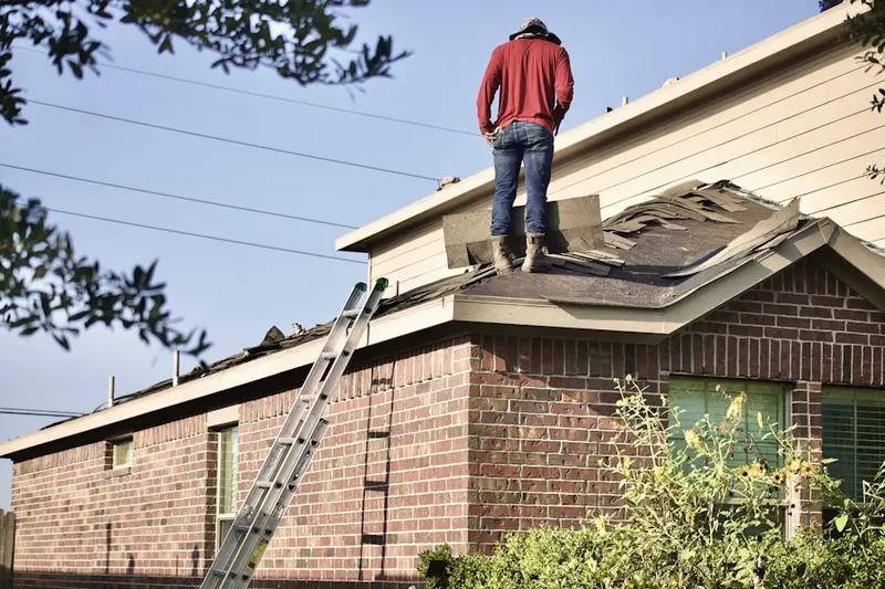 Professional roofer working on a residential roof in Thornton